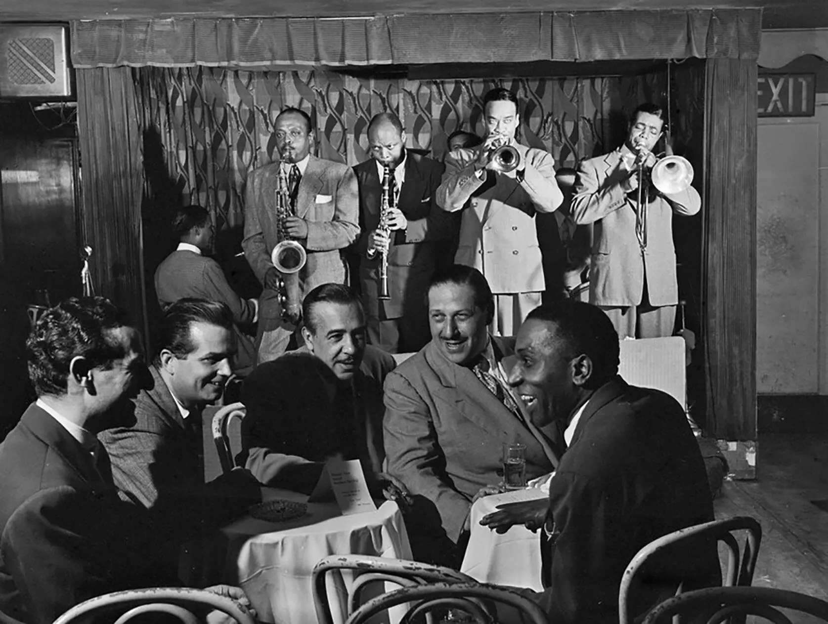Portrait of Ben Webster, Eddie (Emmanuel) Barefield, Buck Clayton, Benny Morton, Joe Marsala, and Cozy Cole, Famous Door, NY